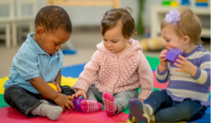 Three babies playing at day care cooperating tr-share model